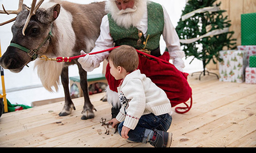 Santa showing a child Rocket reindeer